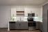 Modern kitchen with sleek cabinetry, stainless steel appliances, and elegant backsplash in a chic apartment.