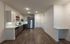 Sleek modern kitchen with stainless steel appliances, elegant cabinetry, and hardwood flooring, perfect for culinary enthusiasts.