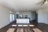 Modern open-concept kitchen with sleek appliances, abundant natural light, and stylish dark wood flooring.