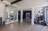Contemporary fitness room with modern equipment and large mirrors, offering a bright and engaging workout environment.