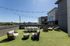 Chic rooftop terrace with modern seating, string lights, and scenic city views, perfect for relaxing and entertaining.