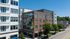 Modern apartment building showcasing vibrant mural, combining stylish architecture with artistic flair in a lively neighborhood.