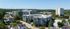 Stunning aerial view of modern apartment complex with lush greenery and spacious surroundings offering a tranquil living environment.