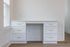 Elegant home office space featuring a sleek white desk with gold handles, perfect for stylish productivity.