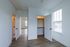 Bright and inviting apartment interior with sleek hardwood floors, spacious closet, and abundant natural light through large windows.