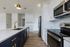 Elegant, modern kitchen with sleek white cabinets, luxurious gold fixtures, and a spacious island counter.