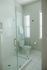 Modern bathroom featuring a sleek glass shower enclosure and elegant tiled floor.