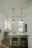 Sophisticated kitchen with sleek pendant lighting, elegant countertops, and a modern faucet, ideal for culinary creations.