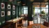 Chic entertainment lounge with vintage record wall art, game tables, and a cozy seating area opening to a lush balcony with city views.