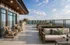 Luxurious rooftop terrace with modern seating, scenic city views, and a stylish outdoor bar setup, perfect for relaxation and entertaining.