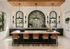 Elegant kitchen interior with modern island seating, lush botanical wallpaper, and stylish pendant lighting, perfect for entertaining.