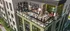 Vibrant communal terrace at a modern apartment building, featuring stylish seating areas and lush greenery, bustling with people enjoying a lively atmosphere.