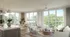 Elegant living space with large windows, natural light, cozy seating, and modern decor overlooking lush greenery.