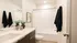 Modern bathroom at RailRunner townhomes featuring clean finishes, a tub shower, and bright, neutral design.