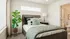Spacious bedroom at RailRunner townhomes with natural light, neutral tones, and an attached bathroom.