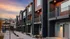 Exterior walkway at RailRunner townhomes showing modern architecture and private entrances.