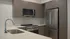 Modern kitchen in the Granger floor plan at Millstone with quartz countertops, stainless steel appliances, oversized island, and contemporary cabinetry.
