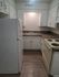 Cozy kitchen featuring white cabinetry, modern appliances, and ample countertop space, perfect for culinary exploration.