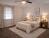 Inviting bedroom with plush carpeting, elegant decor, and ambient lighting, perfect for relaxation.