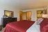 Primary Bedroom facing Ensuite Bathroom & Large Closet