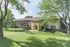 Charming apartment complex with lush green surroundings and sunlit pathways.