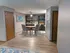 Stylish dining area with round table and chairs, wooden floor, and built-in bookshelf.