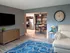 Modern open-plan living room with stylish décor, dining area, and contemporary kitchen.