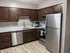 Sleek modern kitchen with stainless steel appliances and wooden cabinetry