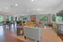 Spacious clubhouse with vibrant seating, large windows, and elegant decor.