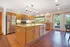 Spacious community kitchen with modern appliances and large island in a stylish clubhouse.