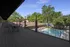 Spacious deck overlooking a serene pool and lush greenery