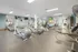Modern apartment gym with exercise equipment and balance balls.