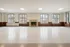 Spacious hall interior with large windows, elegant trim, and a classic fireplace.