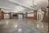 Spacious and elegant open-plan room with chandeliers and wooden paneling