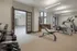 Modern gym with exercise equipment and weights in a bright apartment complex