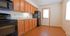Spacious kitchen with wood cabinets, granite countertops, and stainless steel appliances.