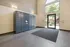Modern apartment lobby with secure package lockers and large sunlit entrance.