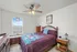 Inviting bedroom with colorful quilt, elegant decor, and natural light