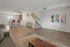 Chic open-concept living area with modern kitchen, cozy breakfast bar, and stylish decor.