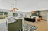 Chic and spacious community lounge featuring modern furniture, stylish lighting, and scenic outdoor views.