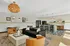 Chic and inviting living space with modern open-concept kitchen, cozy seating area, stylish lighting, and elegant decor.
