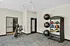Modern fitness room featuring exercise equipment and medicine balls, designed for an active lifestyle.