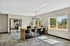 Bright and modern office space with a sleek wood desk, stylish chairs, and large windows offering a beautiful view.