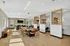 Elegant open-concept communal space featuring modern seating areas, a large dining table, and stylish wooden accents.