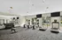 Modern apartment fitness center featuring state-of-the-art treadmills, ellipticals, free weights, and a scenic view through large windows.