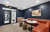 Chic apartment lobby with stylish red leather seating, modern decor, and elegant lighting, perfect for relaxation and welcoming guests.