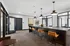 Elegant office space with modern lighting, stylish seating, and sleek black interiors, perfect for productive meetings.