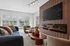 Elegant clubhouse room with modern fireplace, cozy seating, and large windows offering scenic outdoor views.