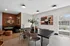 Chic dining area with a sleek black table, stylish chairs, and contemporary artwork, perfect for entertaining.