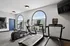 Modern fitness center with large windows, treadmills, and exercise bikes for a bright and energetic workout experience.
